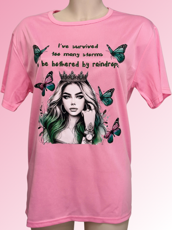 Female pink t-shirt with the woman on it, surrounded by butterfly.