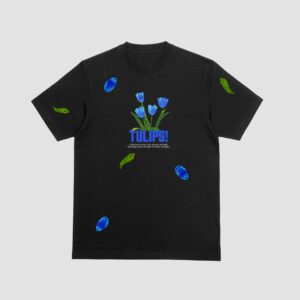 FRONT VIEW OF THE BLACK T-SHIRT WITH A VIBRANT BLUE TULIPS PRINT AND PETALS ON IT.